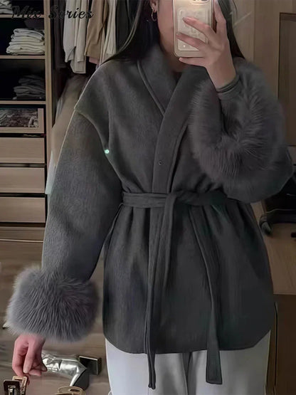 Elegant wool jacket with belt and faux fur cuffs
